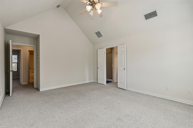 unfurnished bedroom with ceiling fan, high vaulted ceiling, and light colored carpet