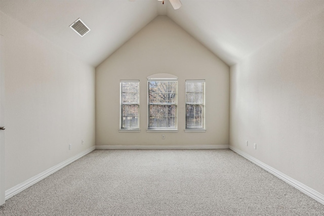 carpeted empty room featuring ceiling fan and lofted ceiling