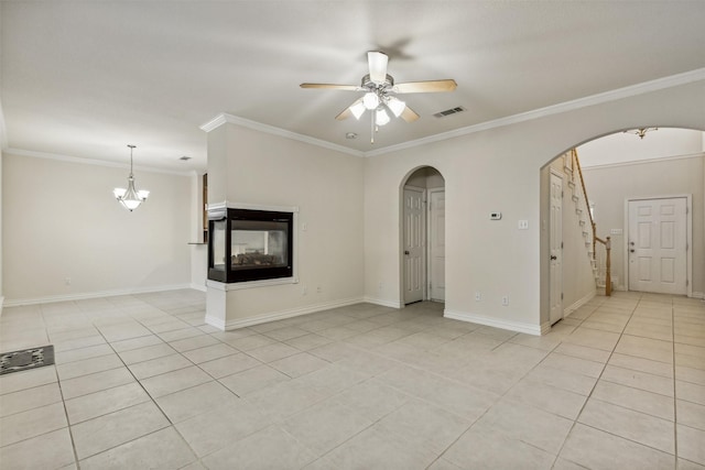 unfurnished living room featuring a multi sided fireplace, crown molding, light tile patterned floors, and ceiling fan with notable chandelier