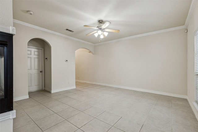 unfurnished room with ceiling fan, crown molding, and light tile patterned floors