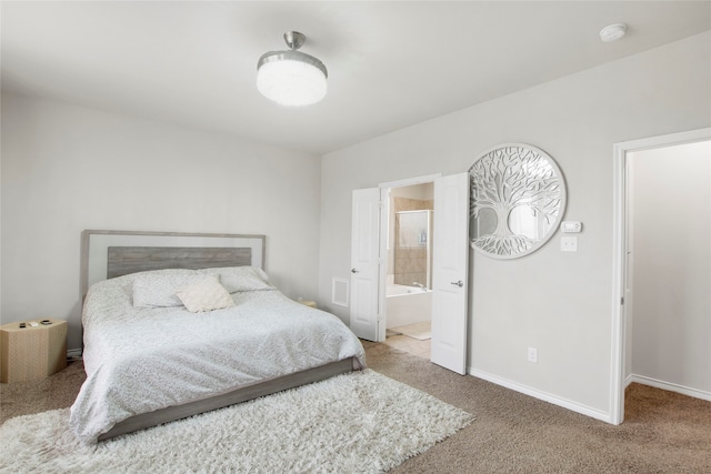 bedroom with light carpet and ensuite bath