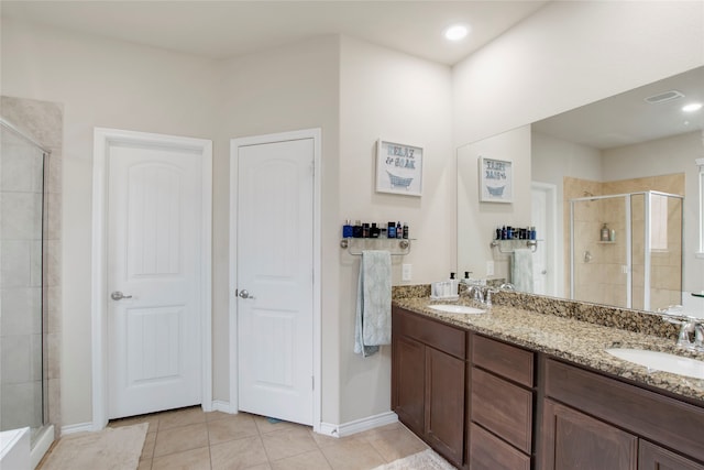 bathroom with tile patterned floors, vanity, and walk in shower