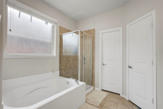 bathroom featuring tile patterned flooring and plus walk in shower