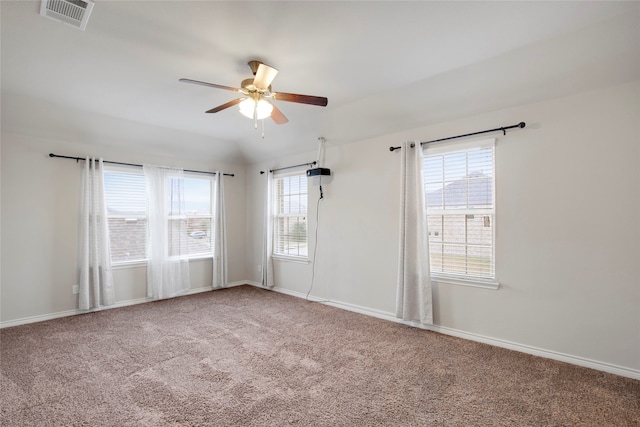 carpeted spare room featuring ceiling fan