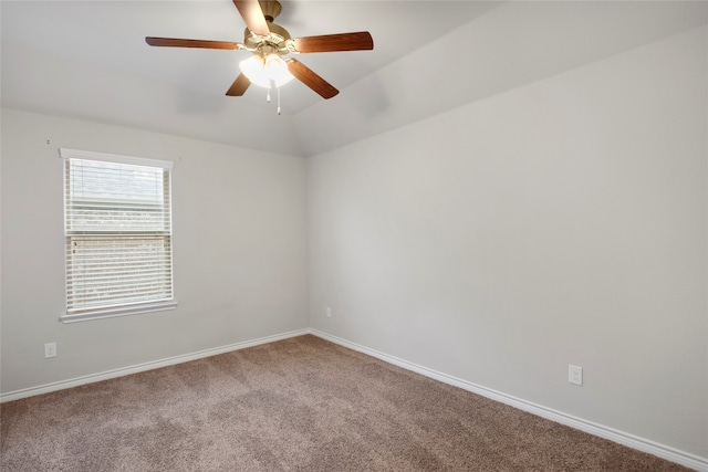 spare room with carpet, ceiling fan, and vaulted ceiling