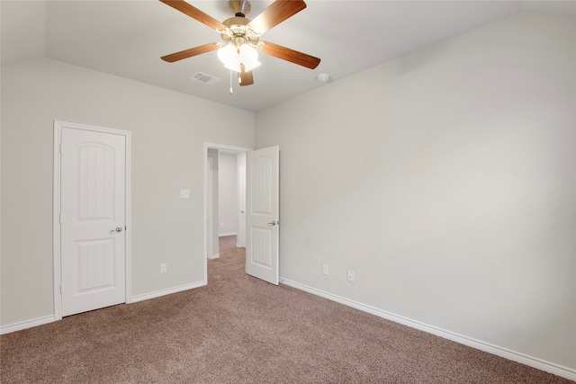 unfurnished bedroom with ceiling fan, carpet, and vaulted ceiling