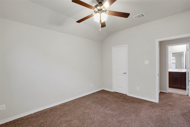 unfurnished bedroom featuring ceiling fan, light carpet, and vaulted ceiling