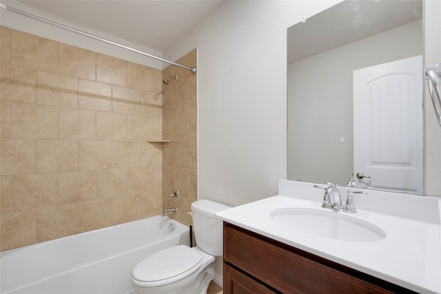 full bathroom with vanity, tiled shower / bath combo, and toilet