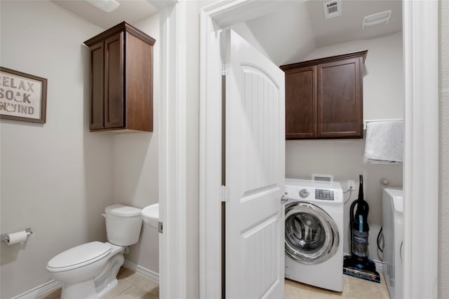 washroom with cabinets, light tile patterned flooring, and washer / dryer