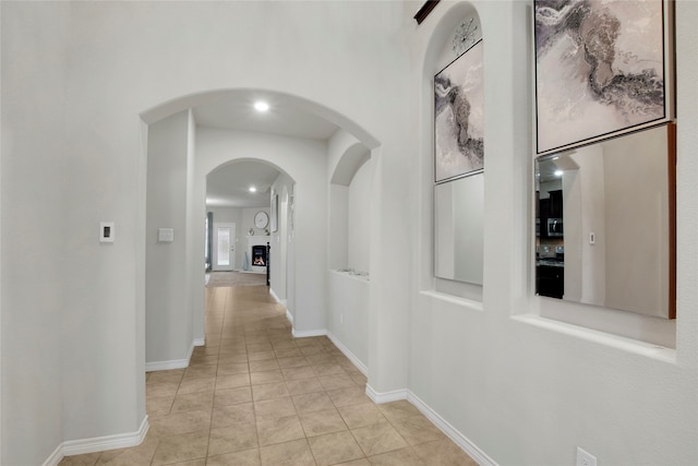 corridor with light tile patterned flooring