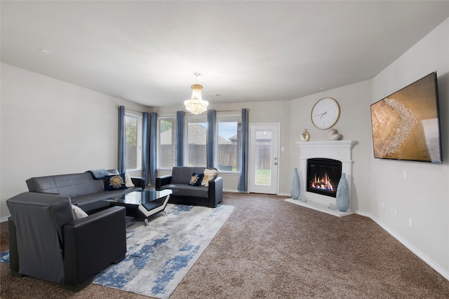 living room featuring dark colored carpet, plenty of natural light, and a notable chandelier