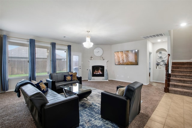 living room featuring a notable chandelier and light tile patterned flooring