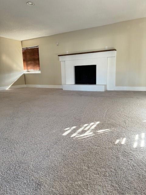 unfurnished living room featuring carpet