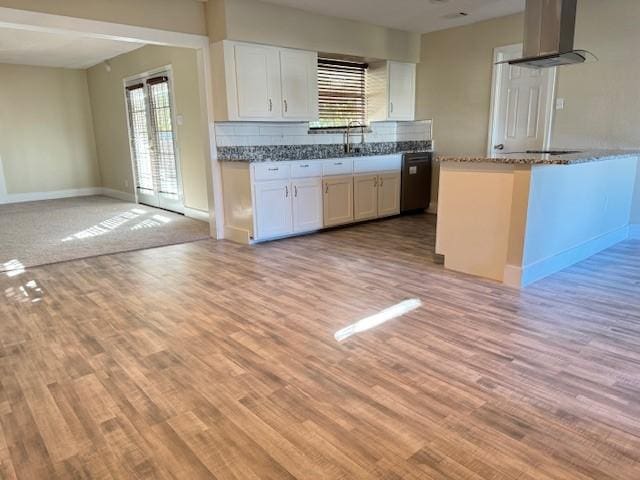 kitchen with white cabinets, exhaust hood, and light hardwood / wood-style flooring