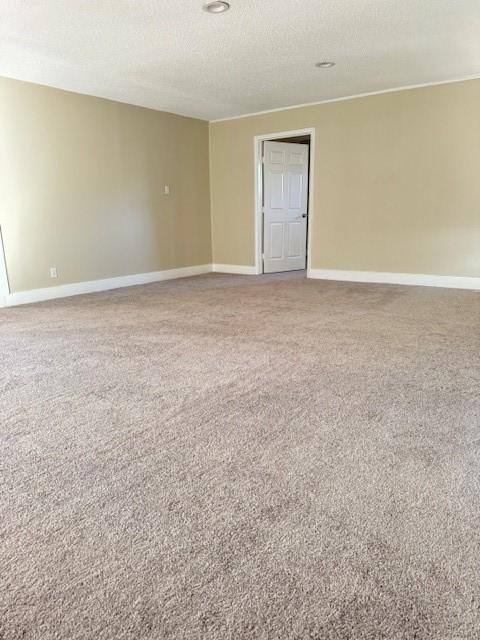 carpeted spare room featuring a textured ceiling