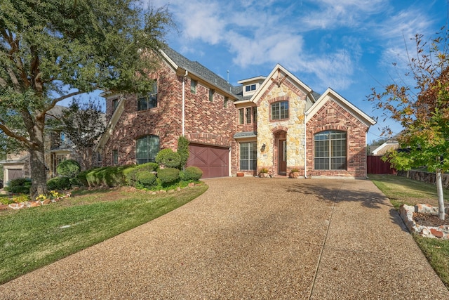 view of front property featuring a garage and a front lawn