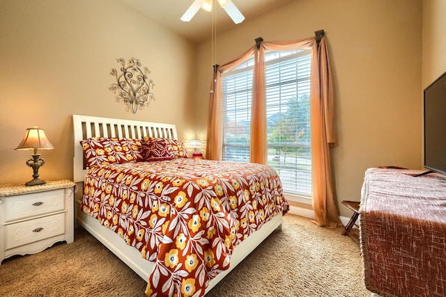 bedroom featuring multiple windows, light carpet, and ceiling fan