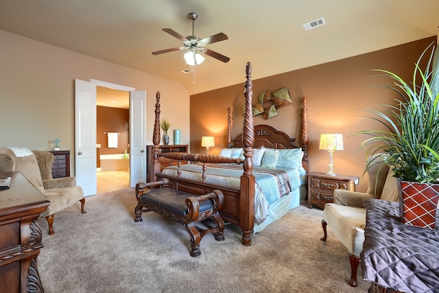 bedroom featuring ensuite bathroom, lofted ceiling, carpet floors, and ceiling fan