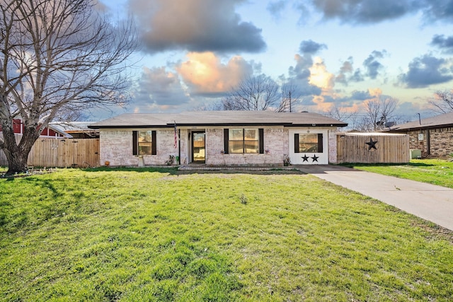 ranch-style home featuring a yard