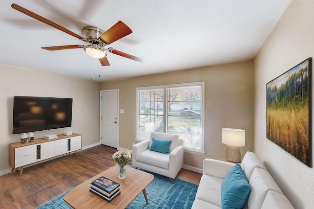 living room with dark hardwood / wood-style floors and ceiling fan