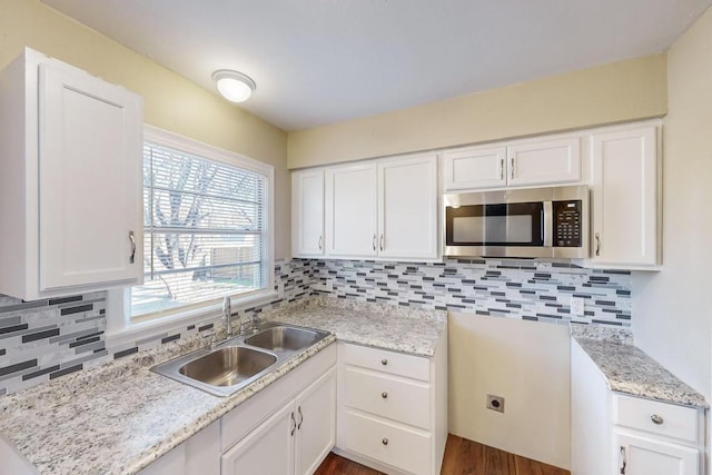 kitchen with sink, backsplash, dark hardwood / wood-style floors, and white cabinets