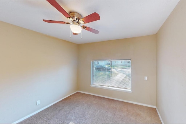 carpeted empty room featuring ceiling fan