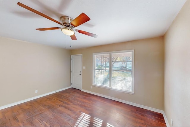 spare room featuring dark hardwood / wood-style flooring and ceiling fan