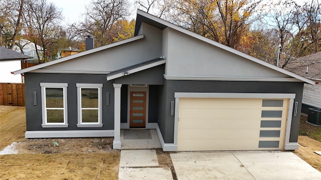 view of front facade with a garage and central AC