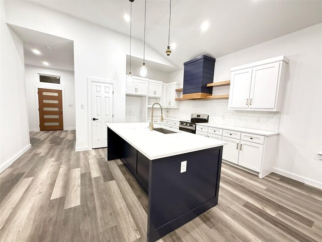 kitchen featuring pendant lighting, sink, a fireplace, appliances with stainless steel finishes, and tasteful backsplash