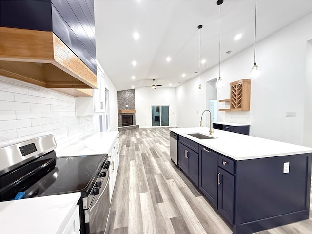 unfurnished living room featuring ceiling fan, a stone fireplace, and wood-type flooring