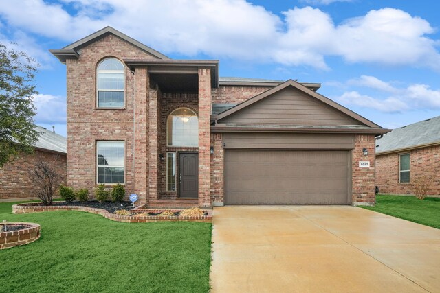 view of front facade featuring a front yard and a garage