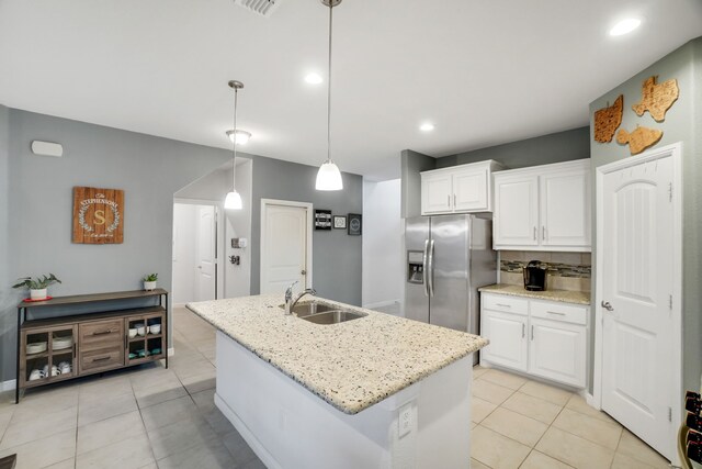 kitchen with washing machine and clothes dryer, white cabinetry, dishwasher, sink, and hanging light fixtures