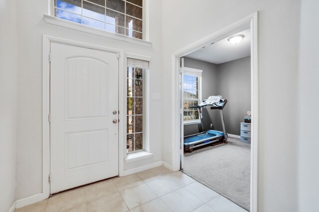 hall with french doors and light tile patterned flooring