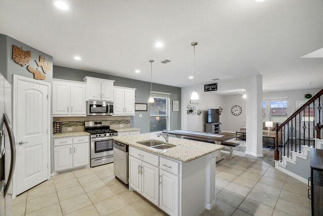 kitchen featuring appliances with stainless steel finishes, white cabinetry, and sink