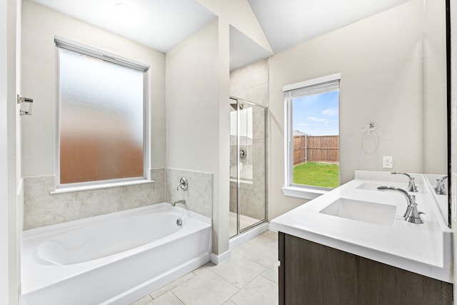 bathroom featuring tile patterned floors, vanity, shower with separate bathtub, and vaulted ceiling