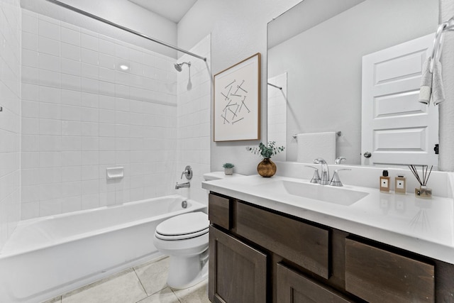 full bathroom featuring toilet, vanity, tile patterned floors, and tiled shower / bath