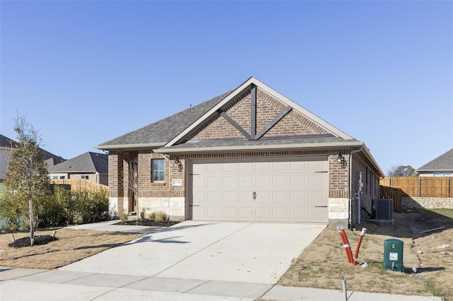 view of front of house featuring a garage and cooling unit