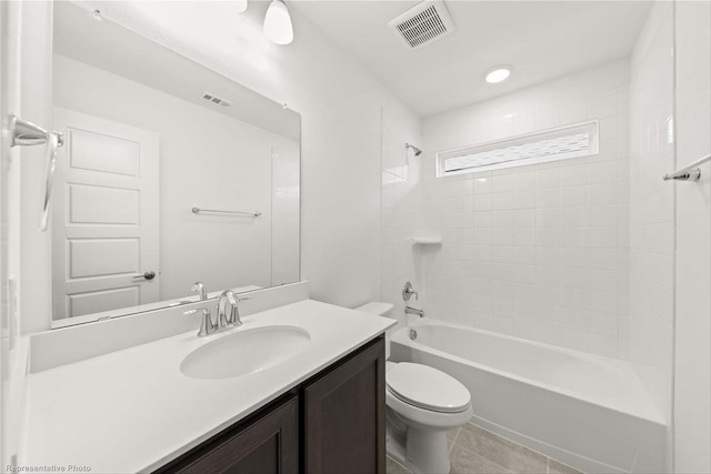 full bathroom featuring tile patterned floors, vanity, toilet, and tiled shower / bath