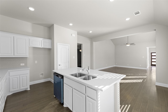 kitchen with white cabinets, dishwasher, dark wood-type flooring, sink, and a center island with sink