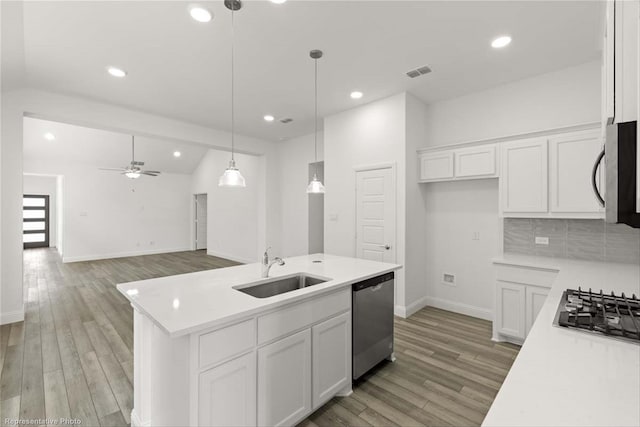 kitchen featuring white cabinetry, sink, a center island with sink, and appliances with stainless steel finishes