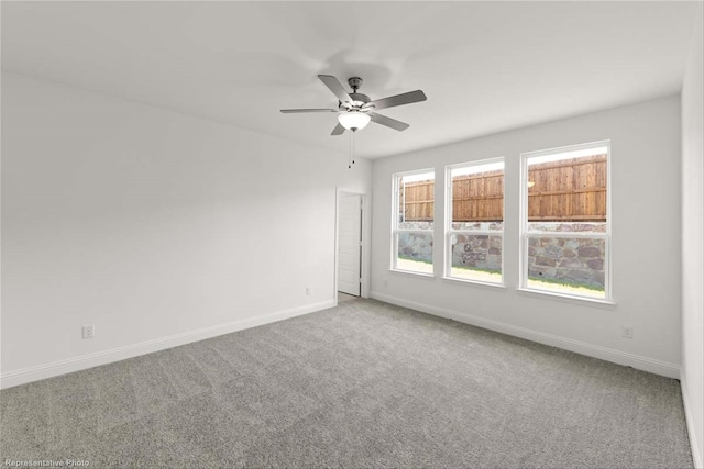 spare room with carpet and ceiling fan