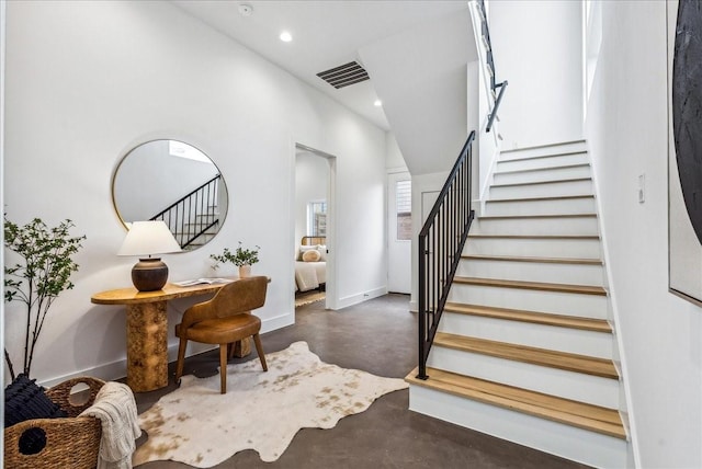 staircase with concrete floors