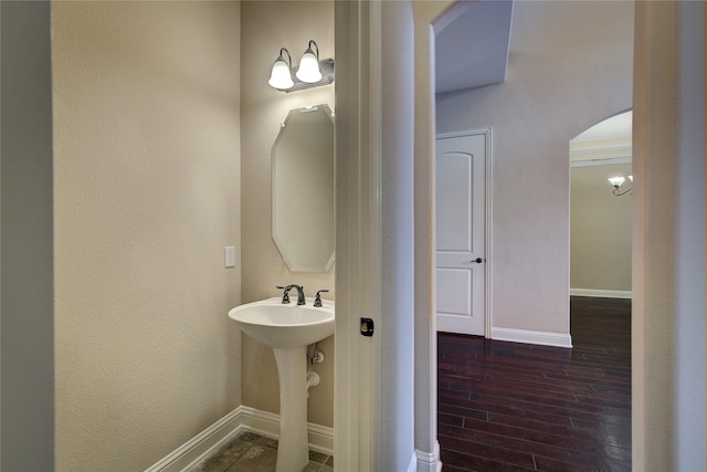 bathroom with baseboards and wood finished floors