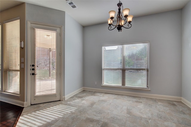 unfurnished dining area with light wood-type flooring and an inviting chandelier