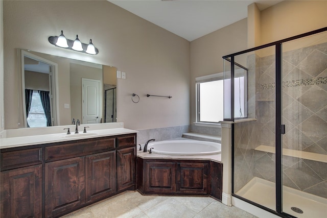 bathroom featuring tile patterned flooring, vanity, and shower with separate bathtub