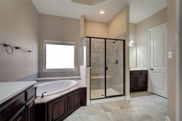 bathroom with vanity and separate shower and tub