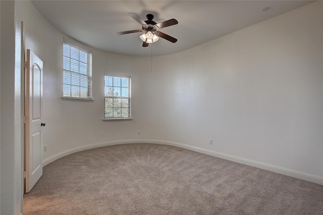 unfurnished room with baseboards, a ceiling fan, and carpet flooring