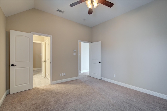 unfurnished bedroom featuring ceiling fan, light carpet, and vaulted ceiling