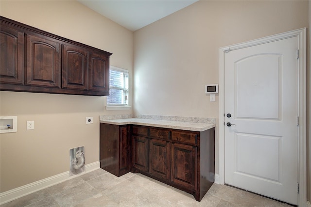 clothes washing area with electric dryer hookup, cabinet space, baseboards, and washer hookup