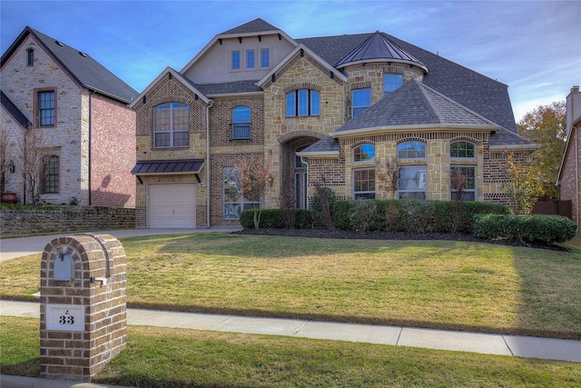 view of front of house featuring a garage and a front lawn